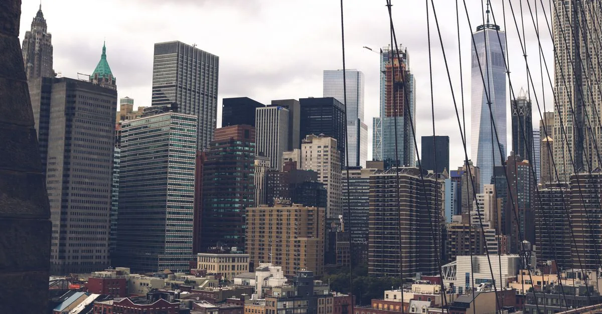 Dramatic view of the New York City skyline and skyscrapers captured from the Brooklyn Bridge